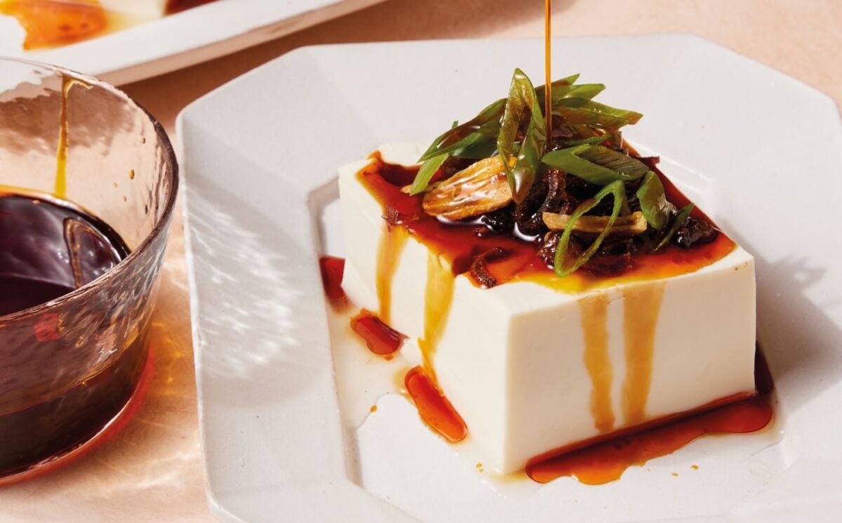 a plate of two-minute tofu with scallions, tamari, sesame oil, and chili crisp