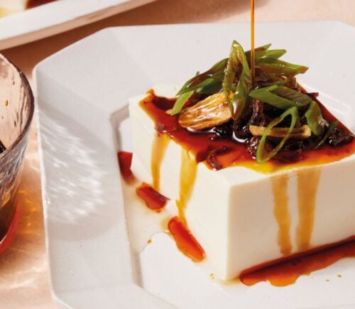 a plate of two-minute tofu with scallions, tamari, sesame oil, and chili crisp