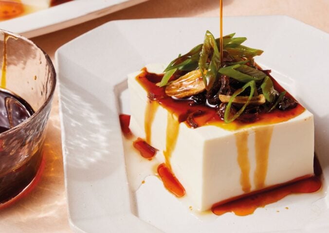 a plate of two-minute tofu with scallions, tamari, sesame oil, and chili crisp