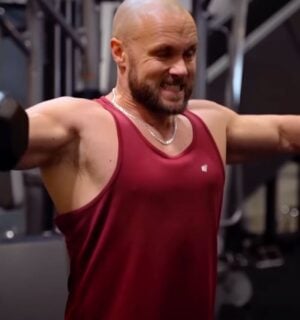 Derek Simnett lifting weights in the gym