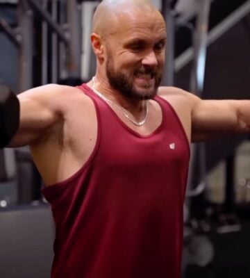 Derek Simnett lifting weights in the gym