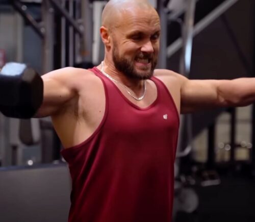 Derek Simnett lifting weights in the gym