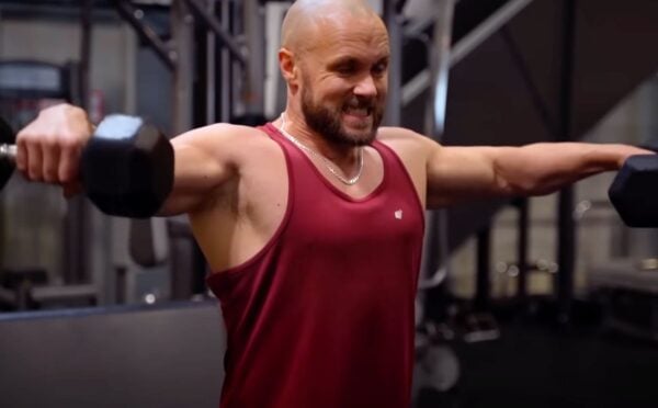 Derek Simnett lifting weights in the gym