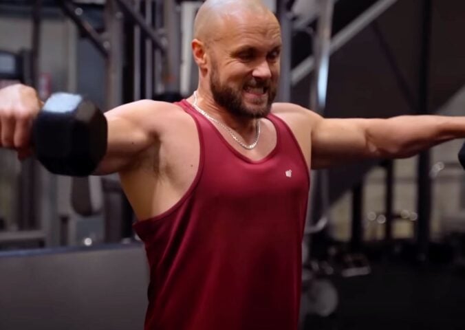 Derek Simnett lifting weights in the gym