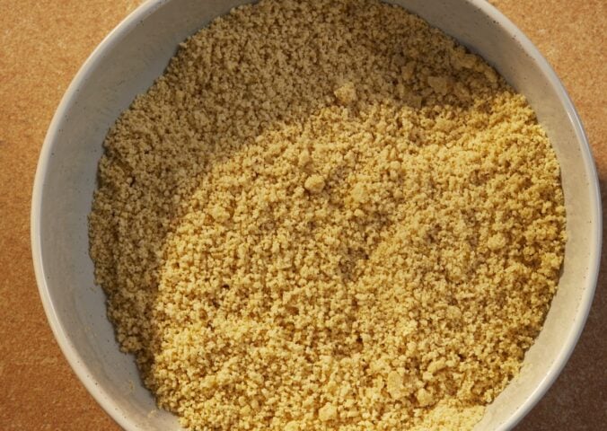 a bowl of vegan parmesan that is dairy-free and made of nuts