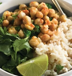 a bowl of warming chickpea coconut curry with cilantro and lime