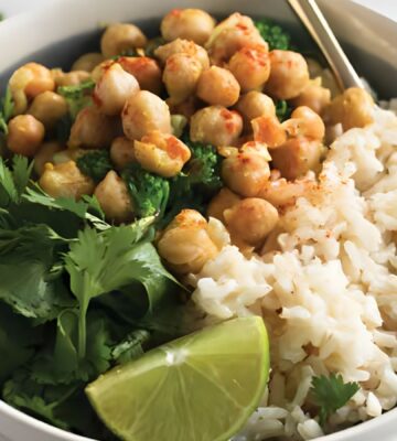 a bowl of warming chickpea coconut curry with cilantro and lime