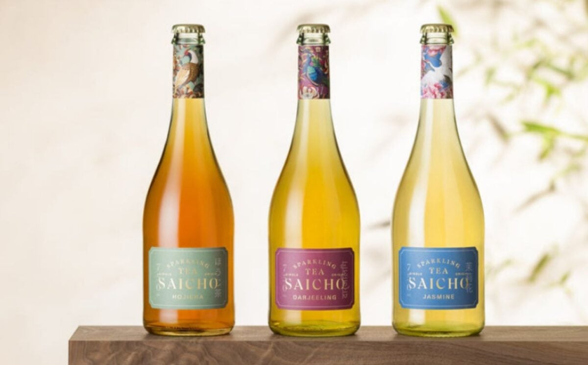 Photo shows three bottles of Saicho sparkling tea on a wooden bench