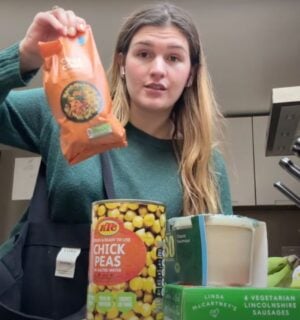 A still of Nicole Whittle, also known as Vegan Beauty Girl, holding up vegan ingredients that were available in 2007