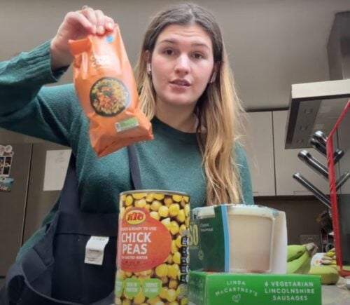 A still of Nicole Whittle, also known as Vegan Beauty Girl, holding up vegan ingredients that were available in 2007