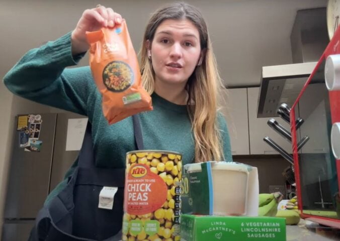 A still of Nicole Whittle, also known as Vegan Beauty Girl, holding up vegan ingredients that were available in 2007