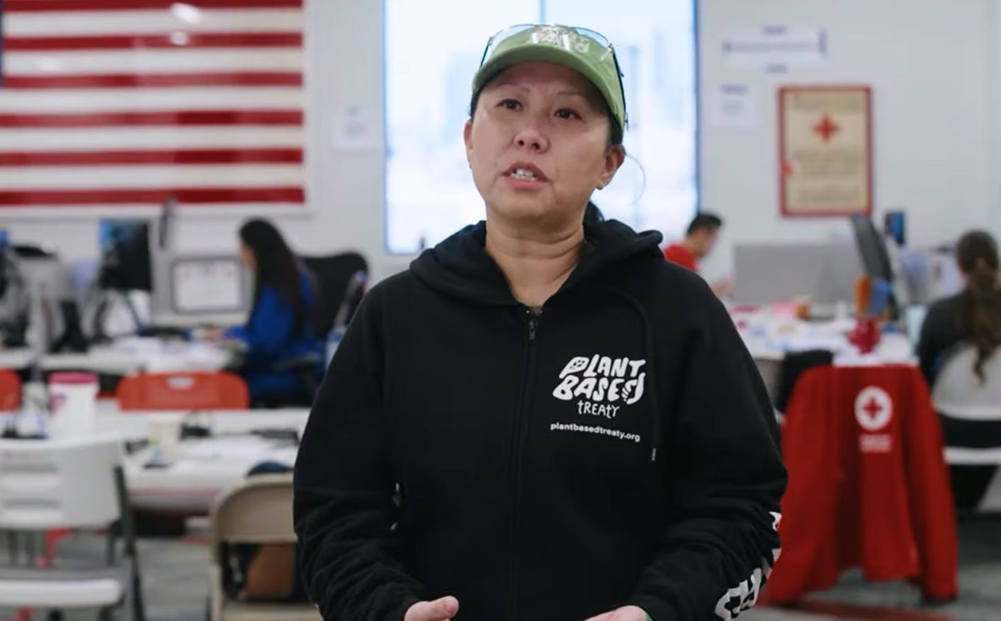 Photo shows Samantha Lau, a campaigner for Plant Based Treaty, talking about the group's collaboration with American Red Cross