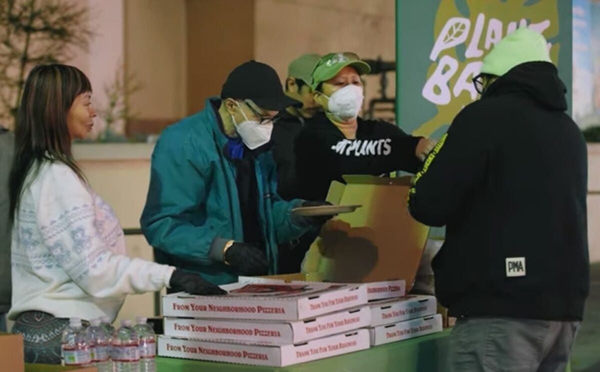 Photo shows Samantha Lau, a campaigner for Plant Based Treaty, working with volunteers to provide plant-based meals at an American Red Cross shelter