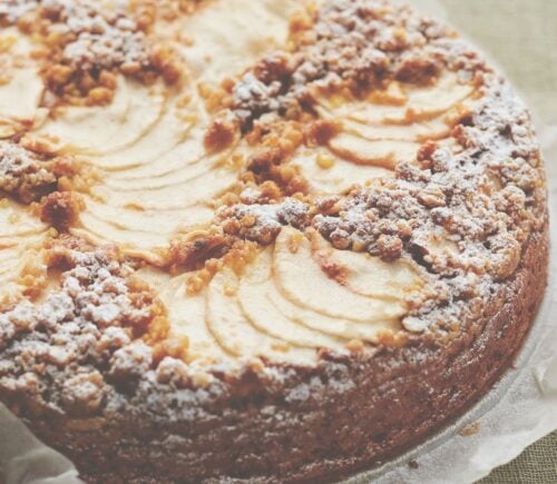 This vegan apple cake is made with cinnamon and topped with apple slices