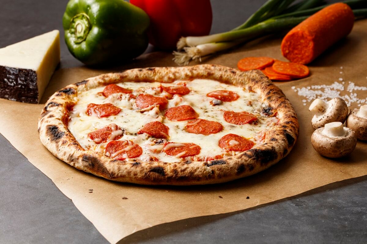 Photo shows a pizza topped with Before the Butcher's vegan pepperoni