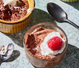 a chickpea chocolate mousse recipe with plant-based cream and raspberries