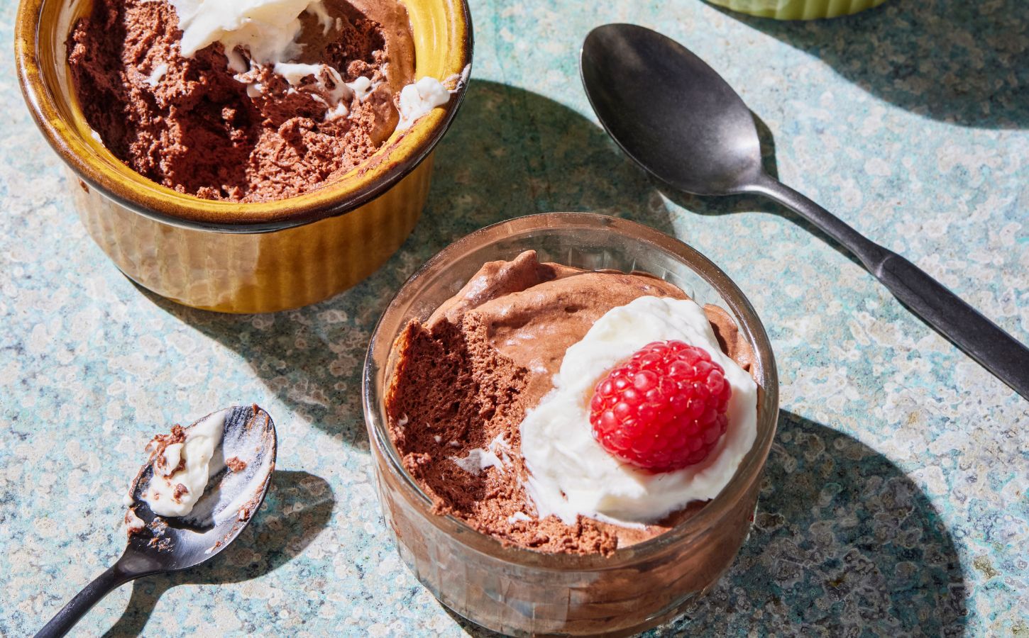 a chickpea chocolate mousse recipe with plant-based cream and raspberries