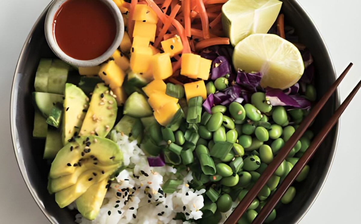 a deconstructed sushi bowl with edamame, avocado, carrot, and mango