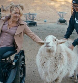 Gretchen Ryan with a sheep at Farm Sanctuary - a still from vegan film "Liberty"