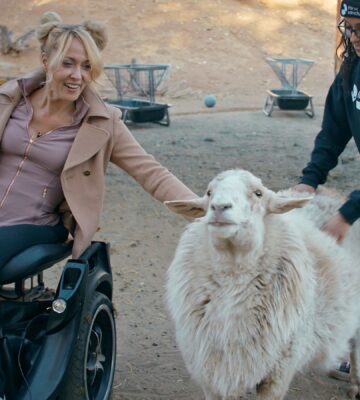 Gretchen Ryan with a sheep at Farm Sanctuary - a still from vegan film "Liberty"