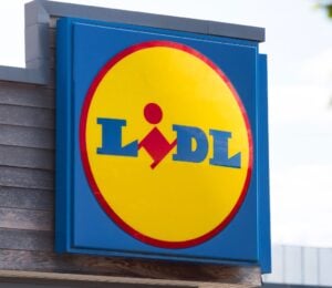 Photo shows a large Lidl sign on the front of a supermarket