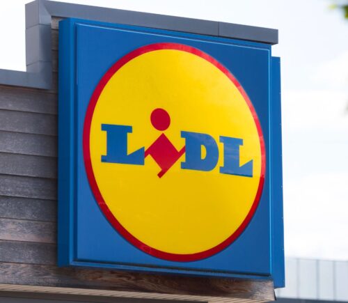 Photo shows a large Lidl sign on the front of a supermarket