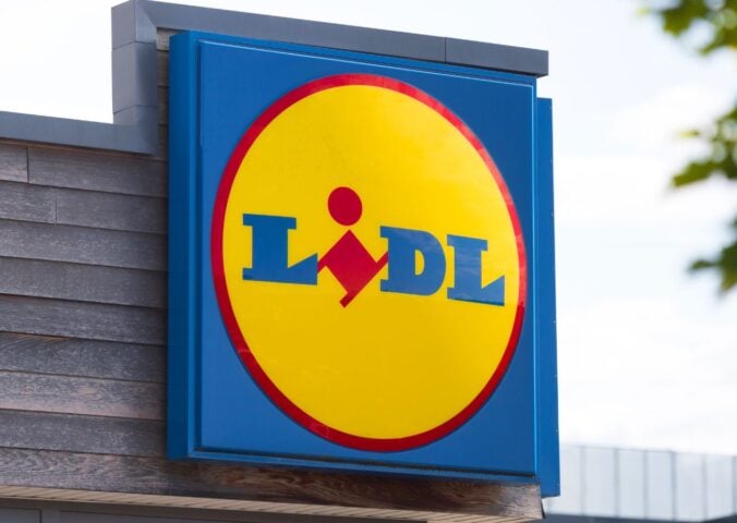 Photo shows a large Lidl sign on the front of a supermarket