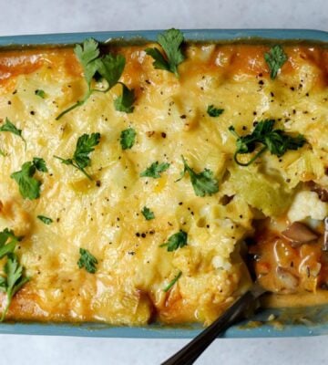 meat-free cottage pie with leek and cauliflower topping plus mushrooms, vegan grated cheese, and herbs