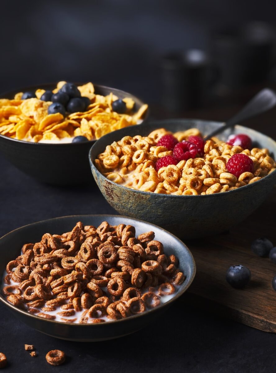 Photo shows three bowls of cereal - M&S's new minimal ingredients range - including Corn Flakes, Multigrain Hoops, and Choco Hoops