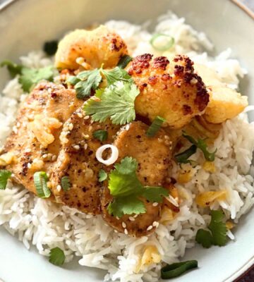 A plate of orange and ginger tofu with rice