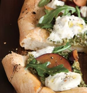 pesto plum pizza with balsamic arugula and basil soy ricotta