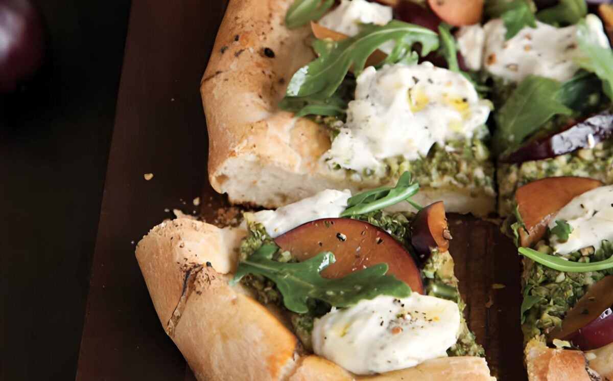 pesto plum pizza with balsamic arugula and walnut pesto