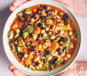 an Ikarian longevity stew filled with beans, chickpeas, lentils, kale, broccoli, part of recipes containing five vegetables or more