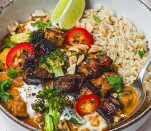 a bowl of roasted aubergine and broccoli lentil curry with brown rice