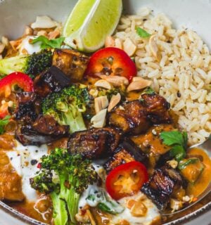 a bowl of roasted aubergine and broccoli lentil curry with brown rice