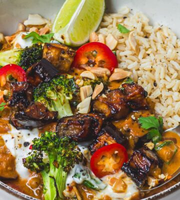 a bowl of roasted aubergine and broccoli lentil curry with brown rice