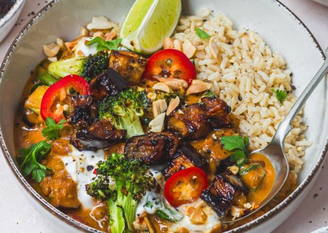 a bowl of roasted aubergine and broccoli lentil curry with brown rice