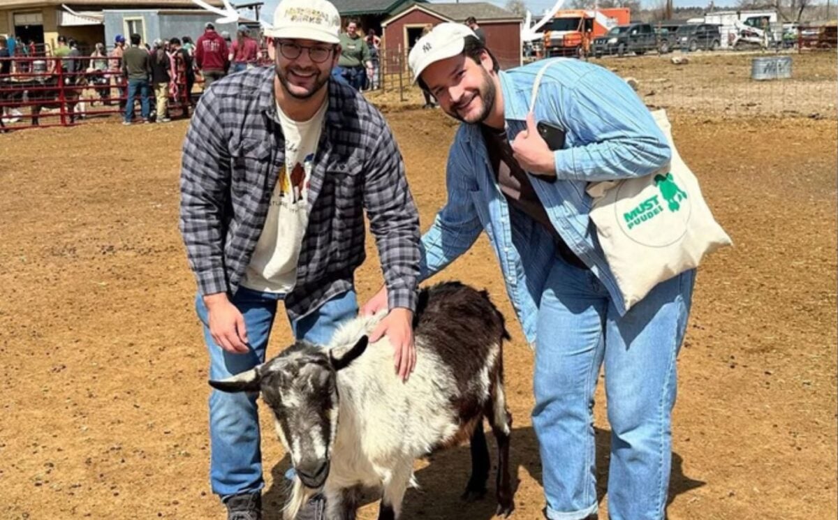 Trupo Treats founders Brian and Charlie Trupo in one of the sanctuaries that they support posing with a goat