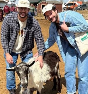 Trupo Treats founders Brian and Charlie Trupo in one of the sanctuaries that they support posing with a goat