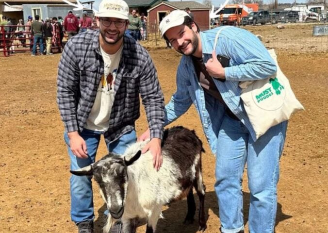 Trupo Treats founders Brian and Charlie Trupo in one of the sanctuaries that they support posing with a goat