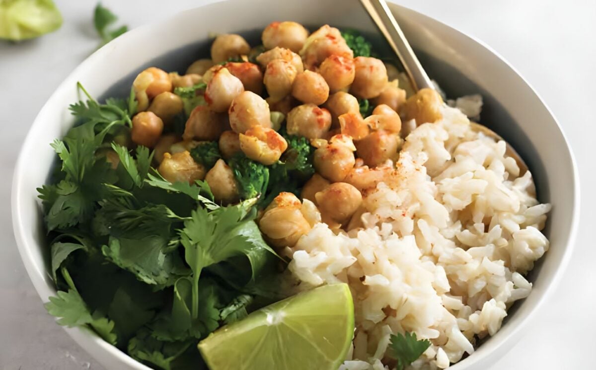 a bowl of warming chickpea coconut curry with cilantro and lime, perfect for vegan power bowl recipes