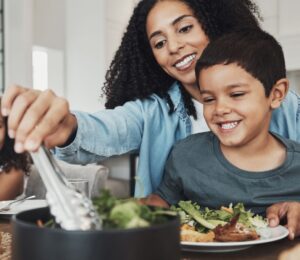 A family sitting down to eat a vegan meal together