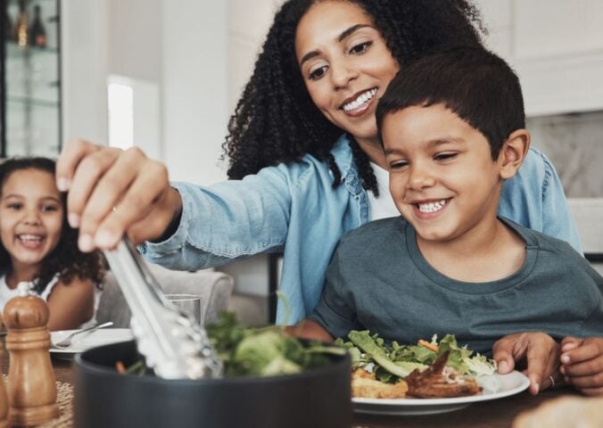 A family sitting down to eat a vegan meal together