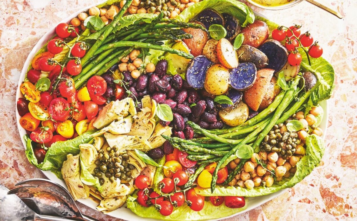 A vegan nicoise salad on a large plate