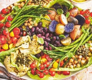 A vegan nicoise salad on a large plate