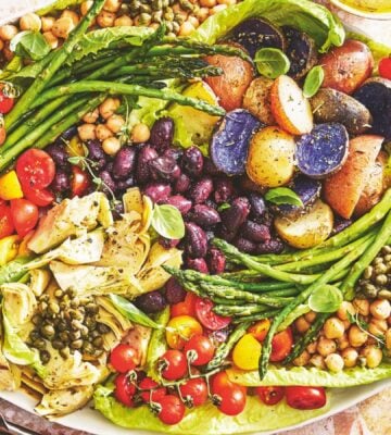 A vegan nicoise salad on a large plate
