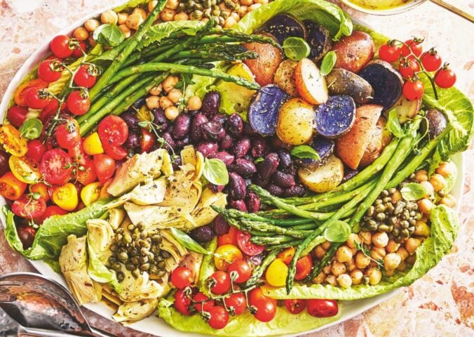 A vegan nicoise salad on a large plate