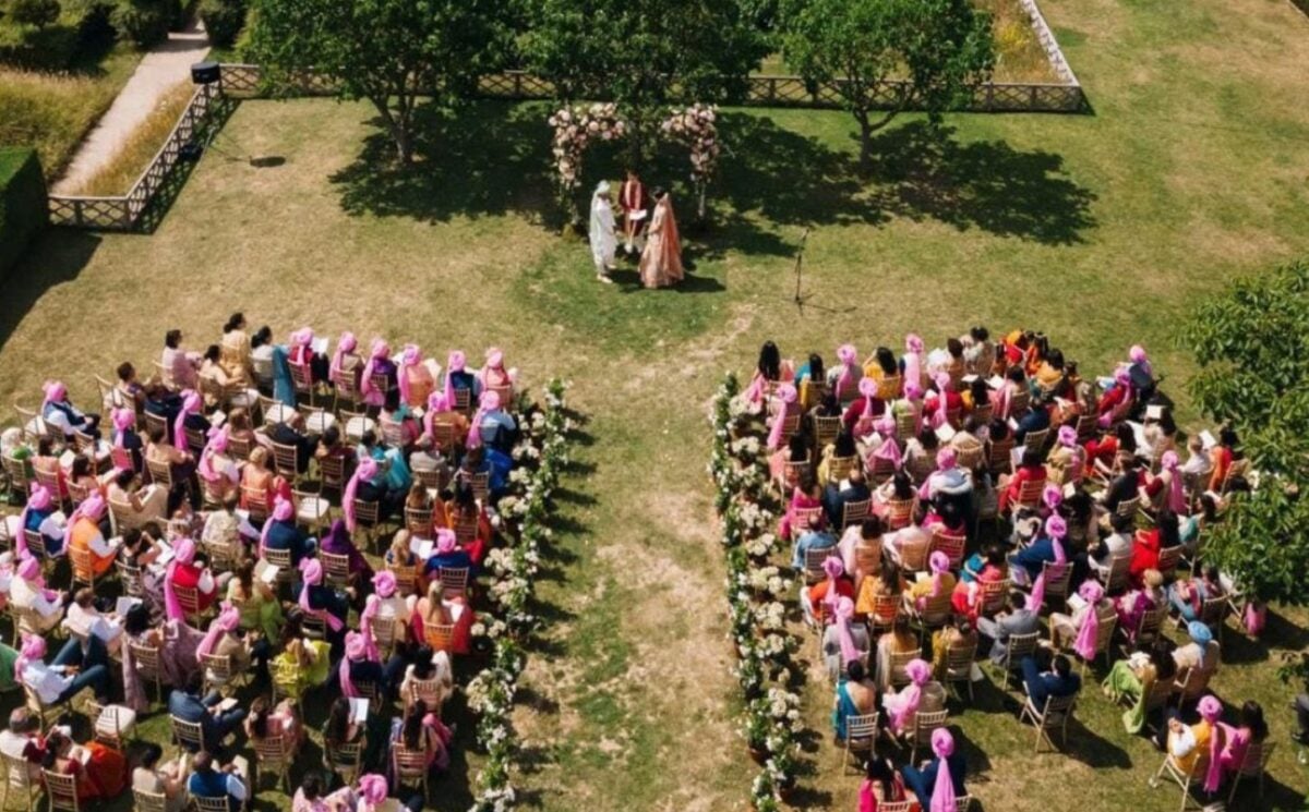 Aerial photo shows Rohini and Siddhant getting married in front of rows of their family and friends in colorful wedding outfits