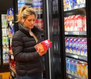 Plant-based YouTuber Candice Hutchings in a still from a video on vegan budget grocery shopping