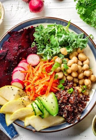 Photo shows a colorful bowl of fresh fruit, vegetables, and salad